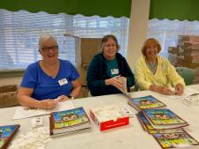 volunteers labeling books