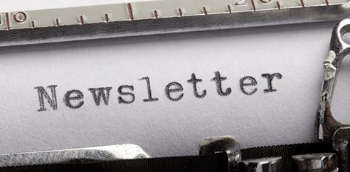 typewriter with the word NEWSLETTER typed on white paper