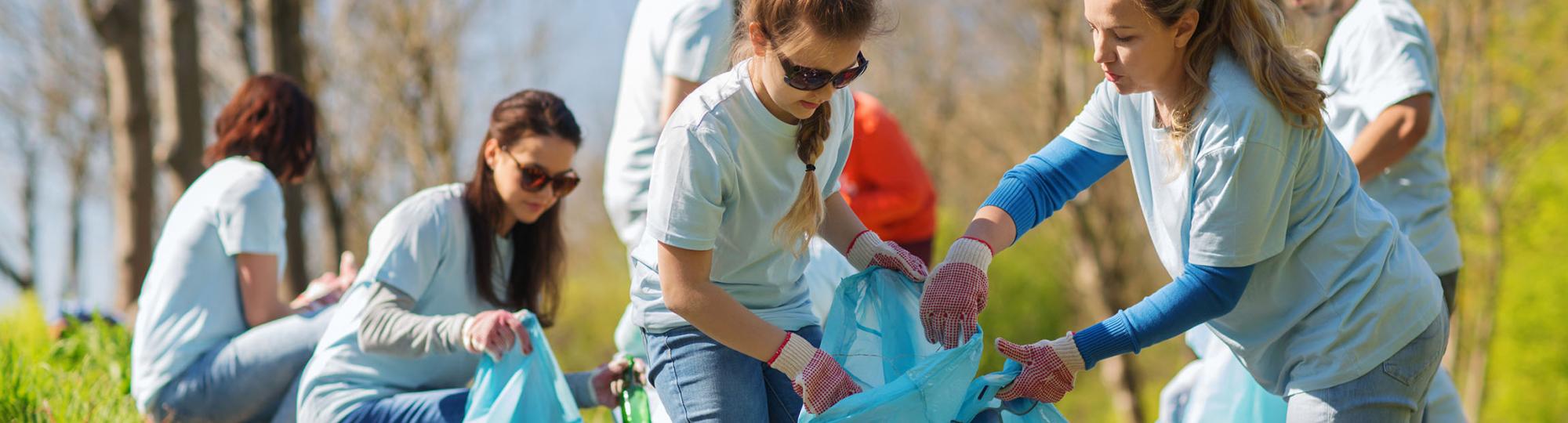group of volunteers picking up trash